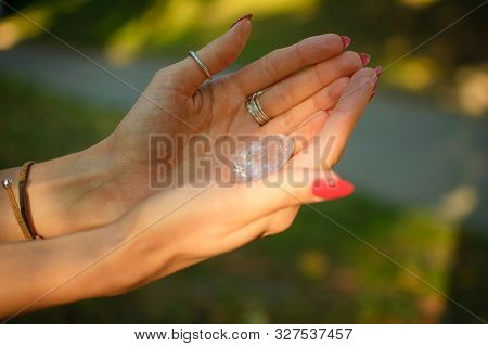 Female Hand With Transparent Amethyst Quartz Yoni Egg For Vumfit, Imbuilding Or Meditation. Shining 