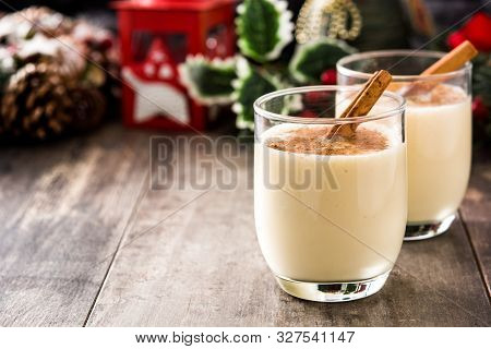 Homemade Eggnog With Cinnamon In Glass On Wooden Table. Typical Christmas Dessert. Copy Space