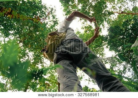 Bottom View Of The Young Adventuress With A Backpack Taking Pictures With A Phone Camera In The Fore