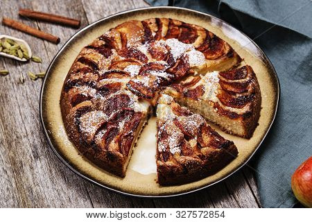 Eplekake. Traditional Norwegian Apple Cake Or Pie Sprinkled Sugar And Cinnamon On Old Rustic Wooden 