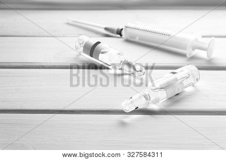 5ml Medical Syringe And Glass Ampoules For Injection On White Wooden Background Vaccine And Vaccinat
