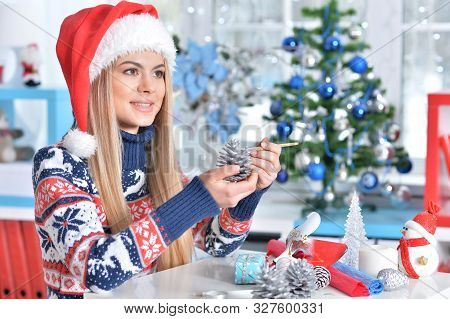 Portrait Of A Smiling Woman Preparing For Christmas
