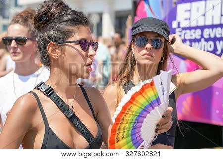 The Annual Parade Lgbt. Lesbians Walking In The Gay Pride Parade. Parade Of Tolerance. Rainbow Flags
