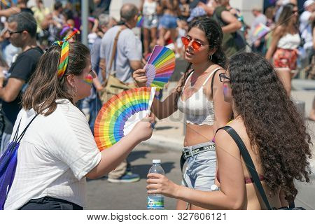 The Annual Parade Lgbt. Lesbians Walking In The Gay Pride Parade. Parade Of Tolerance. Rainbow Flags