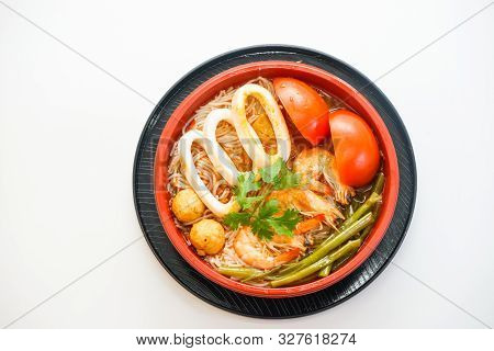 Bowl Of Rice Noodles With Cuttle And Shrimp And Tomato Isolated On White Background