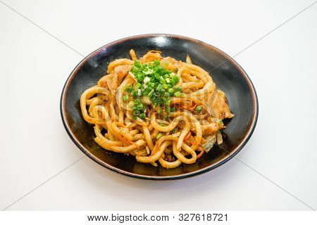 Plate Of Fried Noodle With Pork Meat On White Background. Delicious Asian Spaghetti.