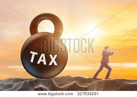 Businessman pulling kettlebell in tax concept