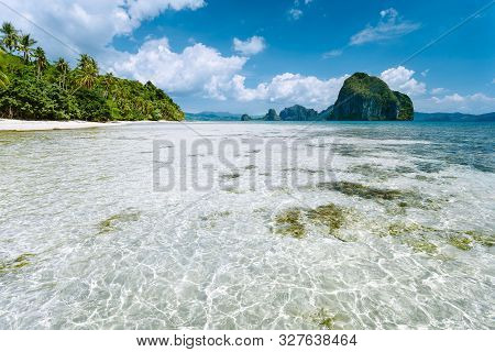 El Nido, Palawan, Philippines. Shallow Lagoon, Sandy Beach With Palm Trees And Amazing Pinagbuyutan 
