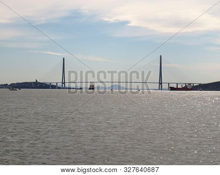 Vladivostok Golden Bridge And Sea Port Under The Cloudy Sky.