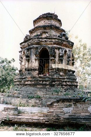 A Sculpture Of The Buddha Sits Inside A Chedi, Among The Ruins Of The Ancient Buddhist Temple Wat Ch