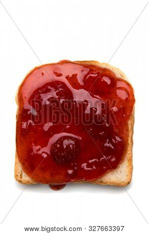 Slice of bread with spread on top isolated over white background