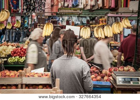 Subotica, Serbia - July 1, 2018: Young Woman Selling Bananas And Peaches On Subotica Buvljak Green M
