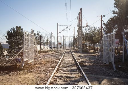 Gevgelija, Macedonia - December 23, 2015: Railway Line Crossing The Border Fence Wall At The Macedon