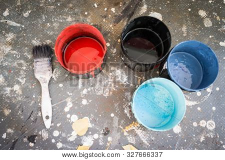 Painting cans on dirty background