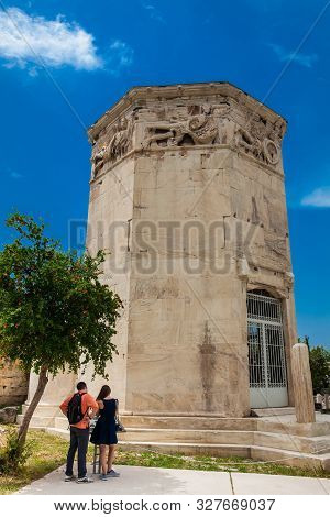 Athens, Greece - April, 2018: Young Couple Of Tourists Visiting The Tower Of The Winds Or The Horolo