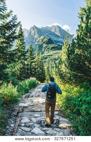 Man walking on hiking trail in Tatra mountains in Poland. Dolina Gasienicowa valley
