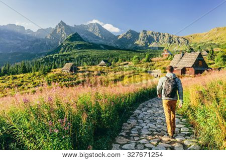 Man walking on hiking trail in Tatra mountains in Poland. Dolina Gasienicowa valley