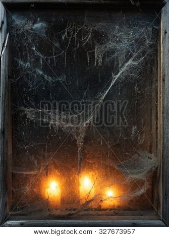 Scary background for the holiday of Halloween. Creepy old spider web in the dark