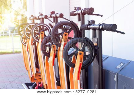 Electric Kick Scooter In Sharing Parking Lot. Scooter Rental Station. New Sharing Business Project.p