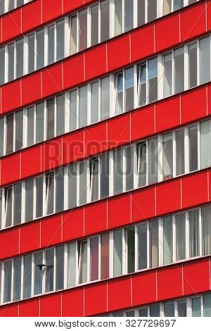 Office Building With Red Façade And Tiltable Windows .