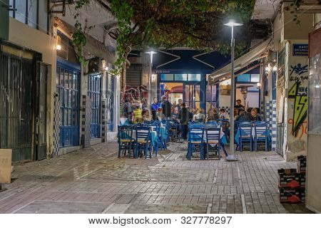 Thessaloniki, Greece - October 12 2019: Hellenic Nightlife Scene Of People At Outdoors Tavern Restau