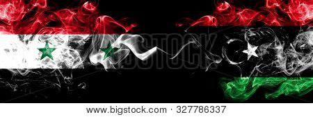 Syria Vs Libya, Libyan Smoke Flags Placed Side By Side. Thick Colored Silky Smoke Flags Of Syrian An