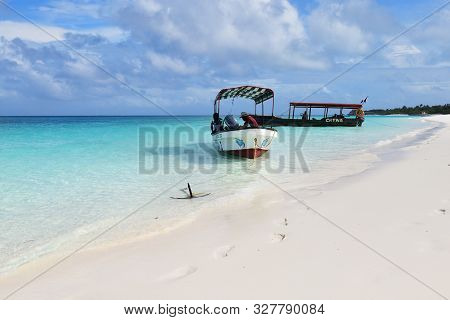 Kendwa, Tanzania - October 3, 2019: Motor Boats With Locals Men Moored On The Kendwa Beach, Zanzibar