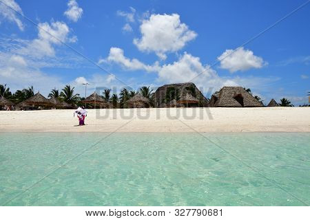 Kendwa, Zanzibar - October 3, 2019: Kendwa Beach. Tanzania, Africa. Local Woman In Traditional Dress