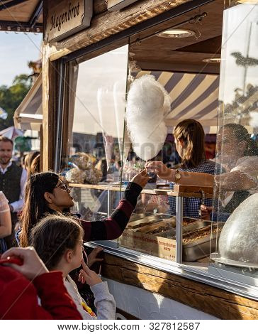 Munich, Germany - 2019 September 28: Young Girl Is Getting Cotton Cancy From A Candy Shops On The Ok