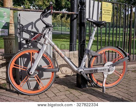 Cambridge, Uk - October 9, 2019: Mobike Bike Share Bicycle Parked Beside Metal Post