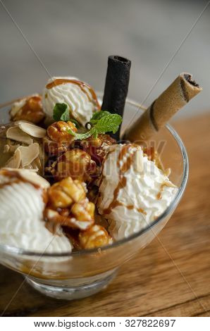 Caramel And Almond Ice Cream With Caramelized Popcorn Sundae Dessert In Glass Bowl