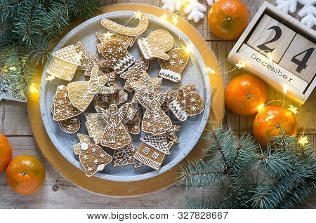 Gingerbread Cookies On A Concrete Tray On A Winter Background With Tangerines, Fir Branches And A Ga