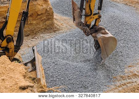 Excavator Moving Gravel In House Under Construction Of Foundation