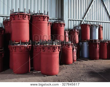 Red Gland Expansion Joints For Heating Main On Concrete Floor. Heat And Power Concept.