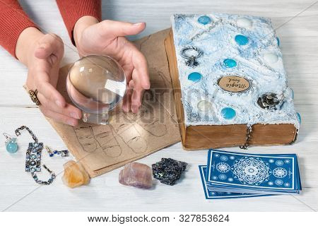Tarot Cards, Crystal Ball, Palmistry Book On A Magic Table Background. Future Reading. Science Of Di
