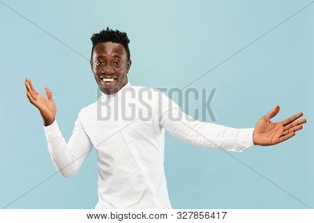 Nice To See You. Young African-american Man Isolated On Blue Studio Background, Facial Expression. B