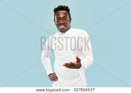 Nice To See You. Young African-american Man Isolated On Blue Studio Background, Facial Expression. B