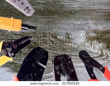 Arrangement Of Crimp Tools To Attaching Computer Network Closeup On Rustic Wooden Background