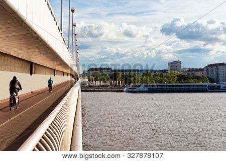 Bicycles On Bridge At Danube River In Donaustadt In Vienna