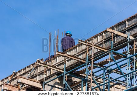 African Construction Workers In Botswana  , Working On A High Building Doing The Structure And The W