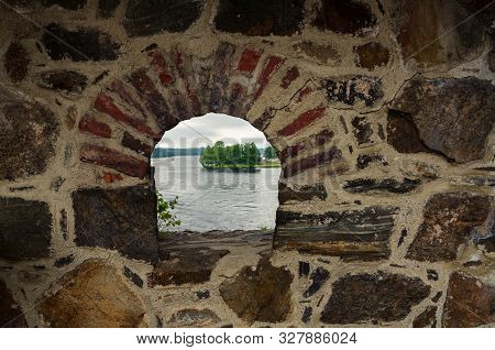 The Fortress Wall Is Made Of Natural Stone With A Loophole. Stones Of Different Colors And Shapes. B