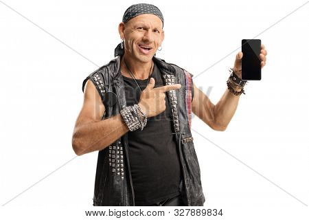 Happy punker holding a smartphone and pointing isolated on white background