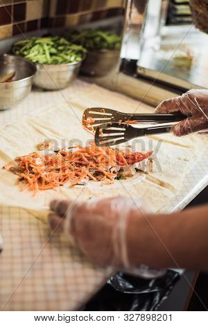 Cooking Fajitos In The Cafe. Cooking Shawarma In Pita In The Kitchen. Wrap Chicken, Carrots, Lettuce