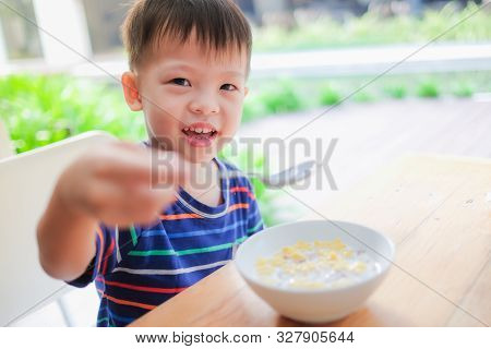 Cute Smiling Little Asian 3 Years Old Toddler Boy Child Wearing Striped T Shirt Use Spoon Eating Cer