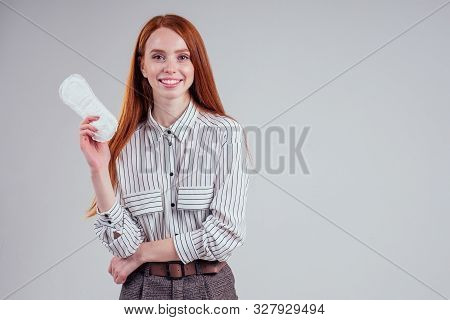 Closeup Photo Of Young Redhead Businesswoman In Striped Shirt Holding Hygiene Pad Choosing Tampon St