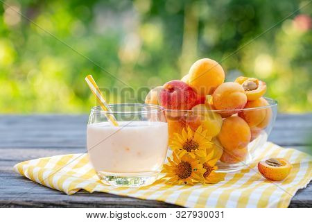 Apricot Smoothie Or Yogurt With Apricots On Wooden Table
