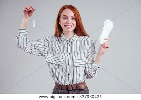 Closeup Photo Of Young Redhead Businesswoman In Striped Shirt Holding Hygiene Pad Choosing Tampon St