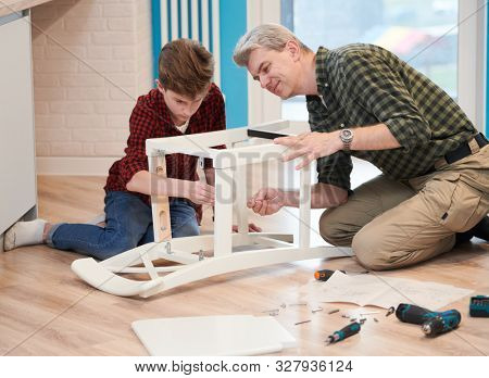 father and son work together. kitchen chair assembling