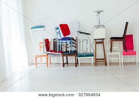 Lots Of Chairs Of Different Colors In The Interior Of The White Room