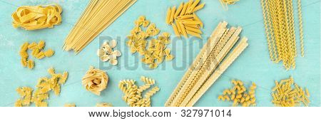 A Panorama Of Italian Pasta Variety, Flat Lay Banner, Overhead Shot On A Blue Background